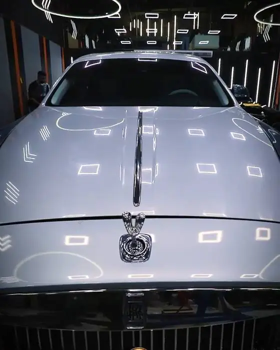 Luxury sedan under the workshop lights