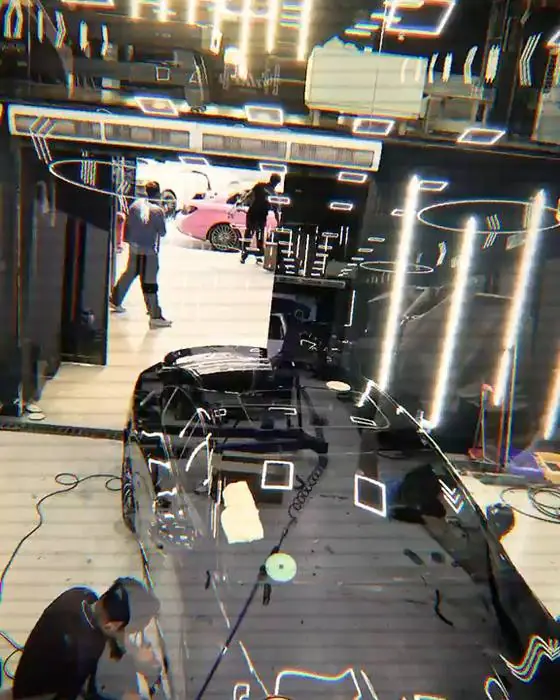 Technician working on a car in the bay